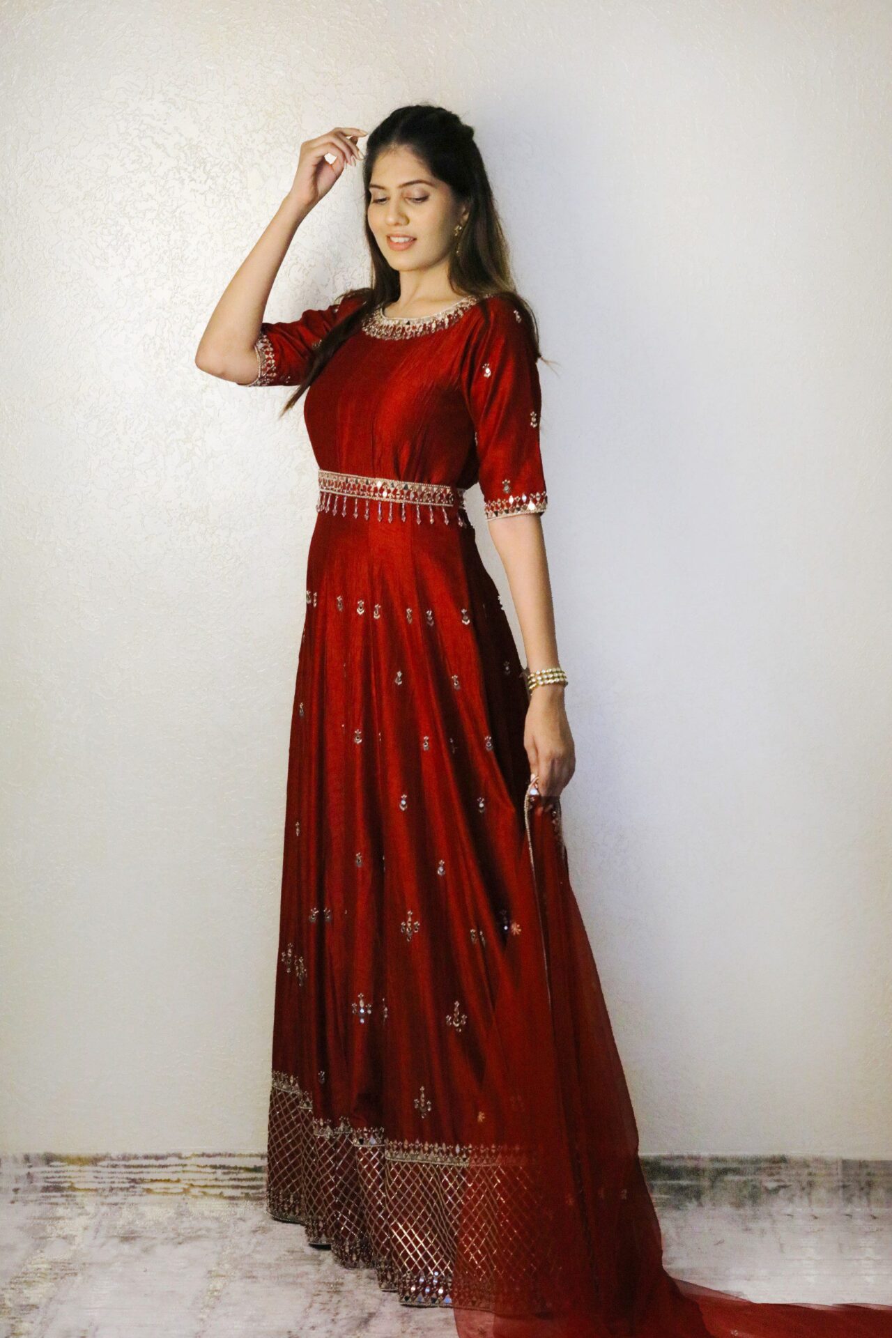 Red anarkali with dupatta and embroidered waist belt.