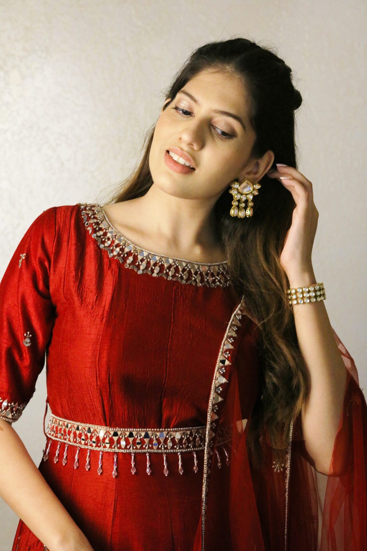 Red anarkali with dupatta and embroidered waist belt.