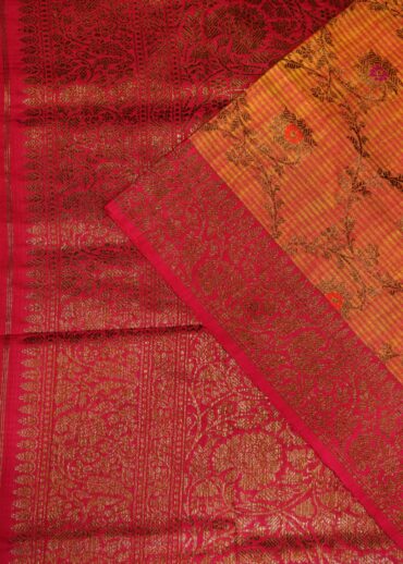 Khadi silk saree in mustard yellow with copper zari meenakari jaal and contrast hot pink zari border with pink contrast blouse.