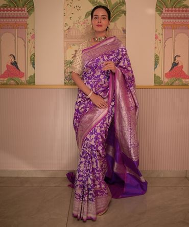 Banarasi silk saree in purple colour with a banarasi silver jaar border and pallu. 