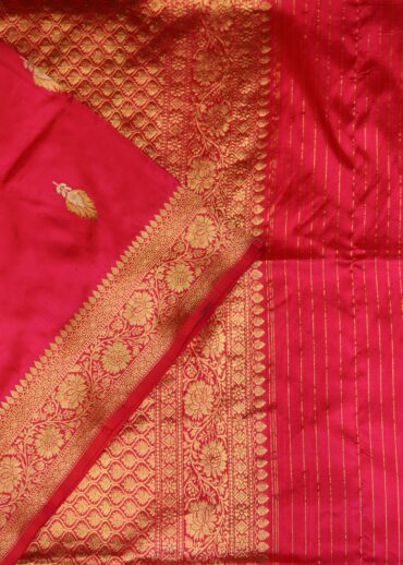 Banarasi silk saree in hot pink colour with all over small zari butis and fancy zari border. Comes with a running blouse.