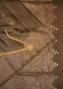 Soft silk saree in grey colour with zari buti, zari pallu and scallop zari border.